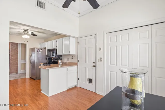 a kitchen with stainless steel appliances a refrigerator and a stove top oven