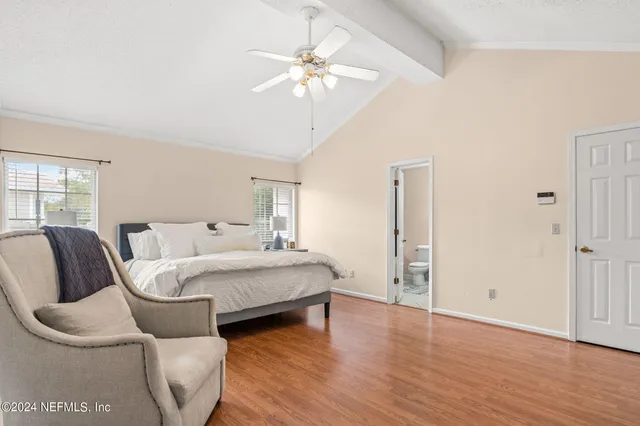 a spacious bedroom with a bed and window