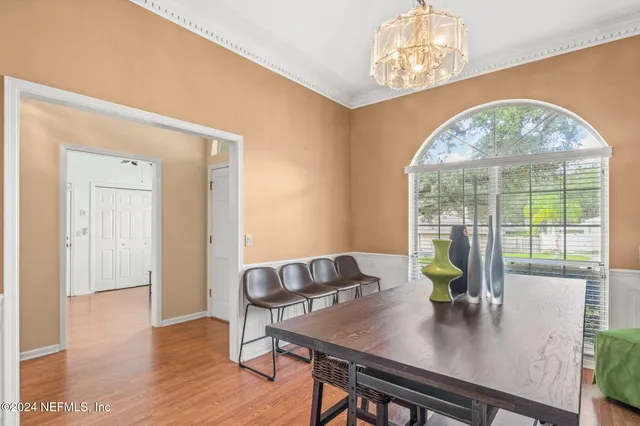 a view of a dining room with furniture and a window