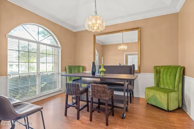 a view of a livingroom with furniture and a large window