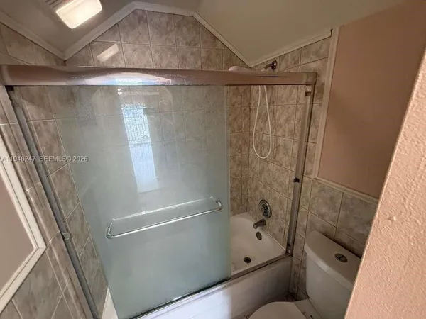 a bathroom with a shower and a toilet