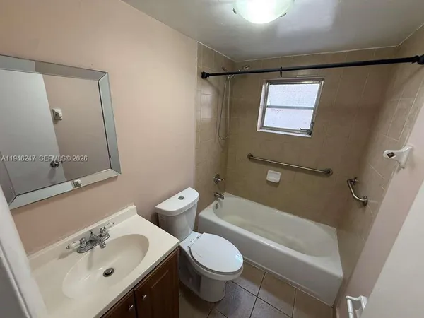 a bathroom with a sink mirror vanity and toilet