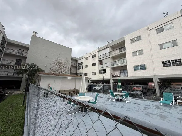 a building outdoor space with patio furniture and potted plants