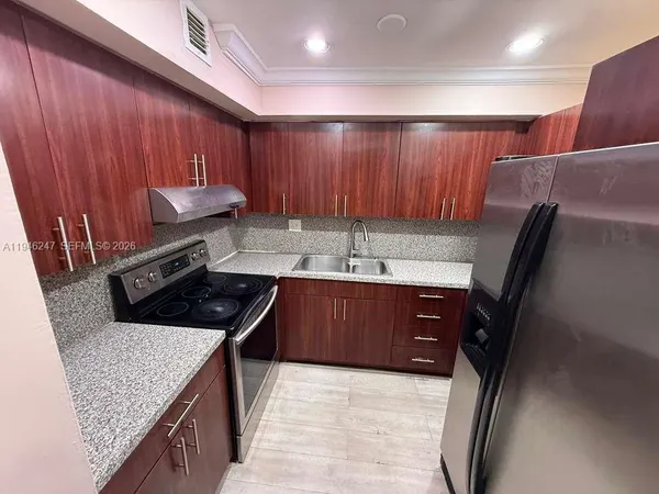 a kitchen with a sink a stove top oven a sink and dishwasher