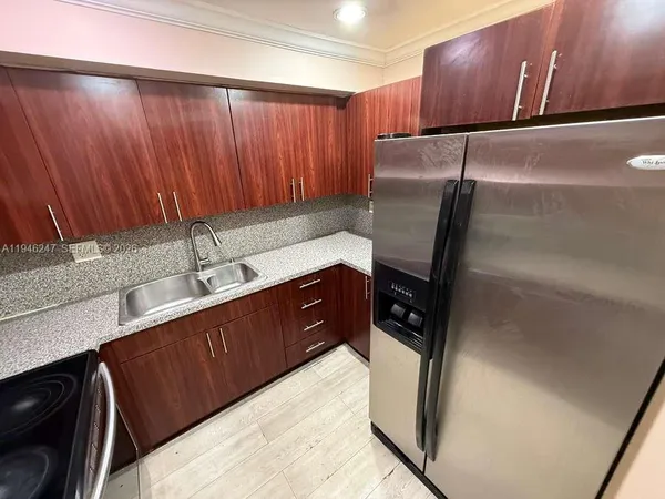 a kitchen with a sink and cabinets