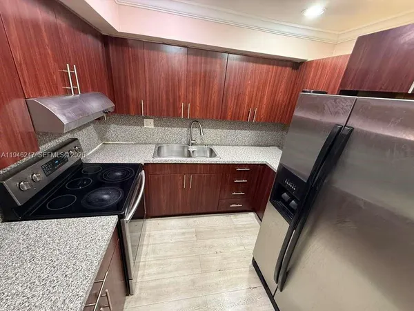a kitchen with a sink and cabinets