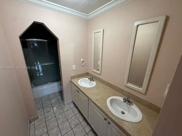 a bathroom with a granite countertop sink toilet and mirror