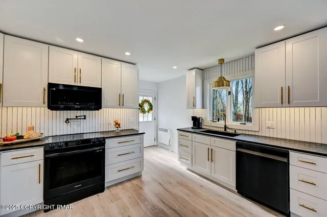 a kitchen with stainless steel appliances granite countertop a stove and a sink