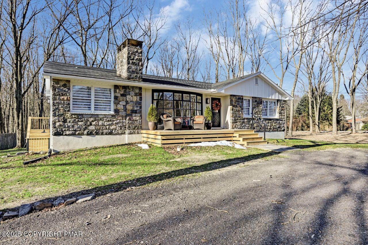 205 Winona Road Mount Pocono, PA 18344 - Photo 2 of 47 a view of a house with a yard patio and a large tree