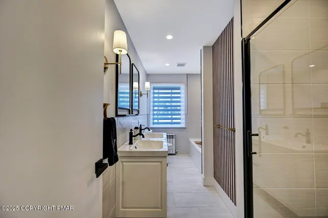 a bathroom with a bathtub and a shower