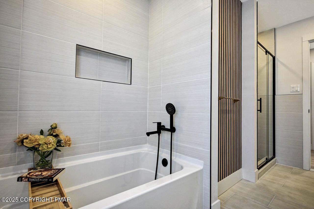 205 Winona Road Mount Pocono, PA 18344 - Photo 25 of 47 a bathroom with a bathtub and a shower