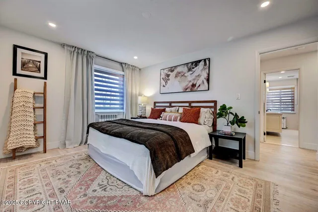 a bedroom with a bed and a painting on the wall