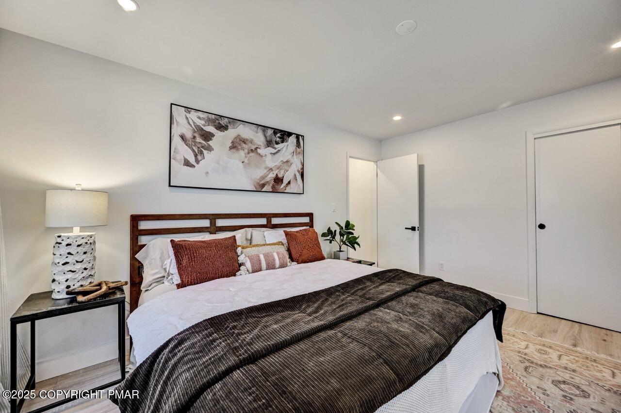 205 Winona Road Mount Pocono, PA 18344 - Photo 29 of 47 a bedroom with bed and paintings on the wall