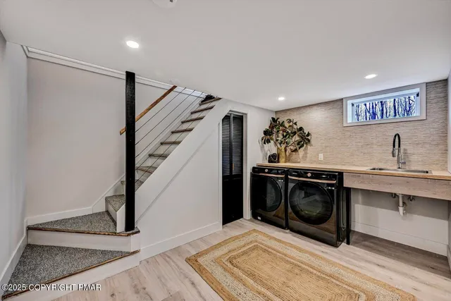 a view of a white house with a big yard and large trees