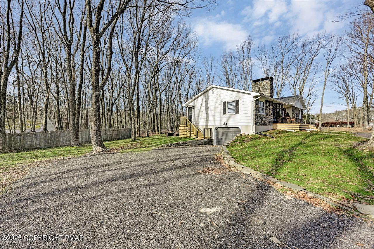 205 Winona Road Mount Pocono, PA 18344 - Photo 45 of 47 a view of a white house with a big yard and large trees
