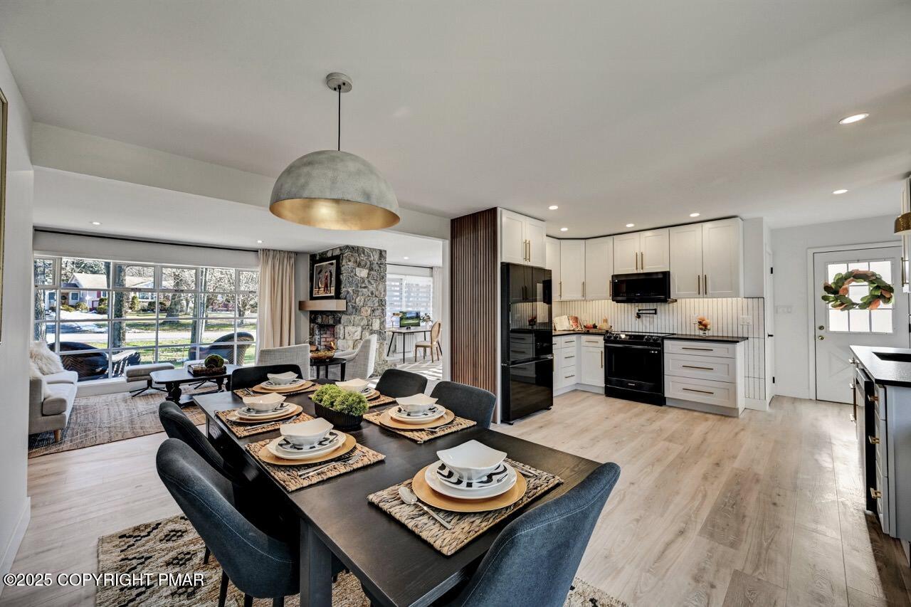 205 Winona Road Mount Pocono, PA 18344 - Photo 10 of 47 a open dining room with furniture wooden floor kitchen view and a chandelier