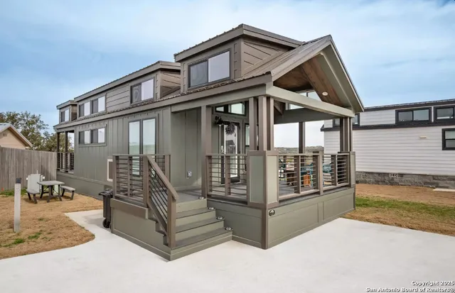 a view of a house with wooden floor and fence