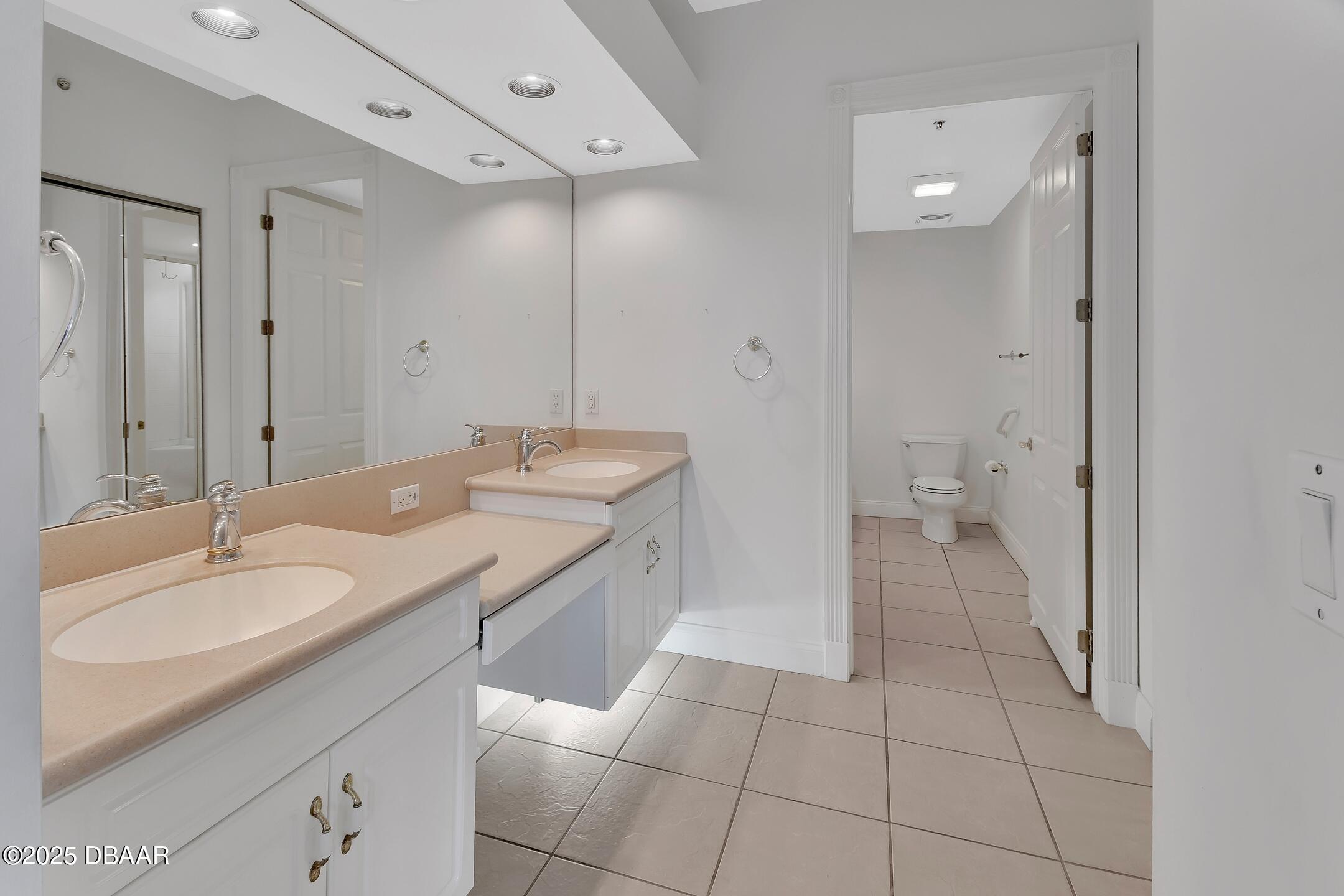 4623 Rivers Edge Village Lane, Unit 6308 Ponce Inlet, FL 32127 - Photo 12 of 55 a spacious bathroom with a granite countertop sink mirror and a toilet