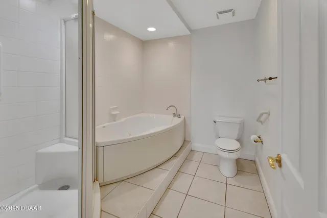 a bathroom with a tub and shower
