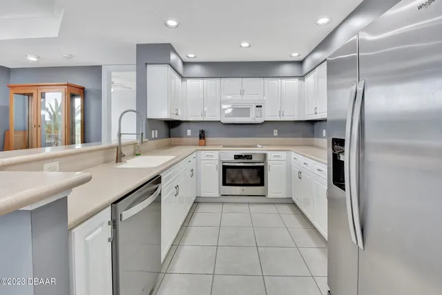 a bathroom with a granite countertop sink a mirror and a toilet