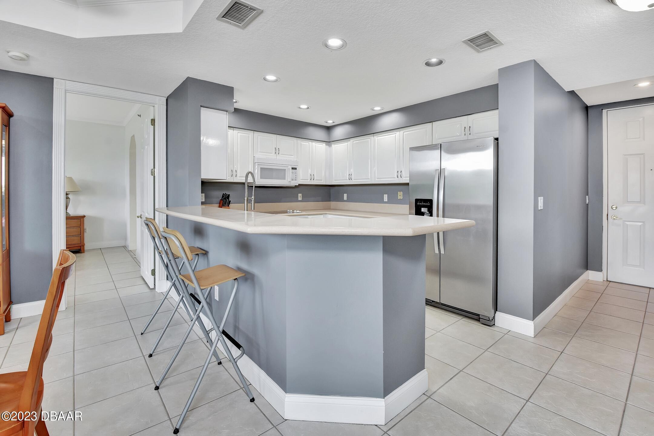 4623 Rivers Edge Village Lane, Unit 6308 Ponce Inlet, FL 32127 - Photo 20 of 55 a kitchen with kitchen island cabinets and a sink