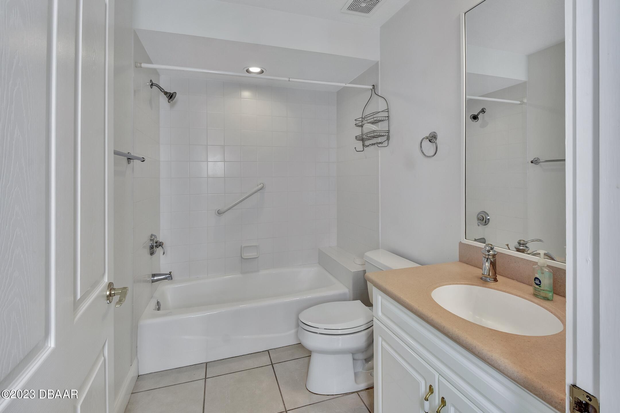 4623 Rivers Edge Village Lane, Unit 6308 Ponce Inlet, FL 32127 - Photo 26 of 55 a bathroom with a granite countertop toilet a sink and bathtub