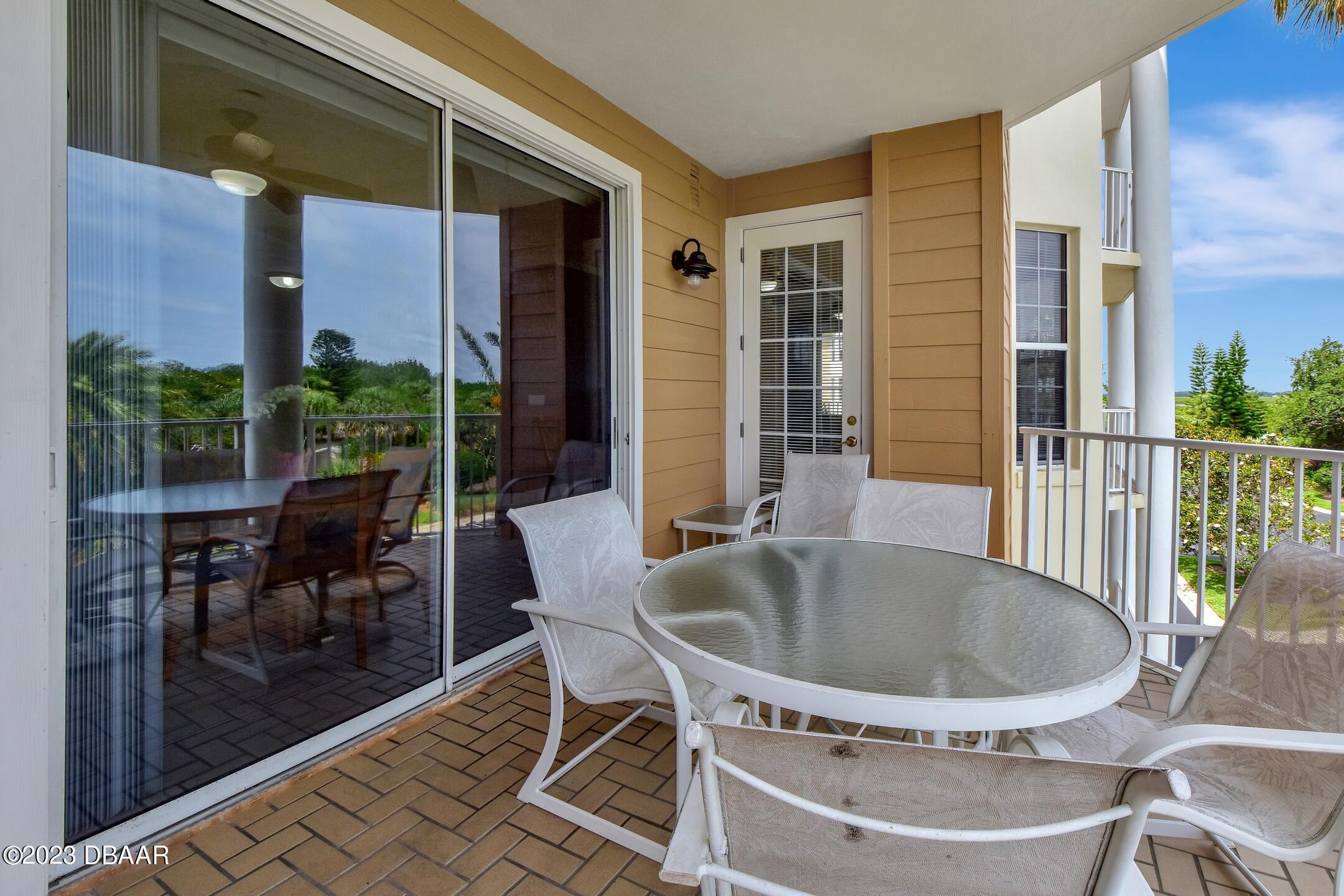 4623 Rivers Edge Village Lane, Unit 6308 Ponce Inlet, FL 32127 - Photo 27 of 55 a view of a patio with table and chairs