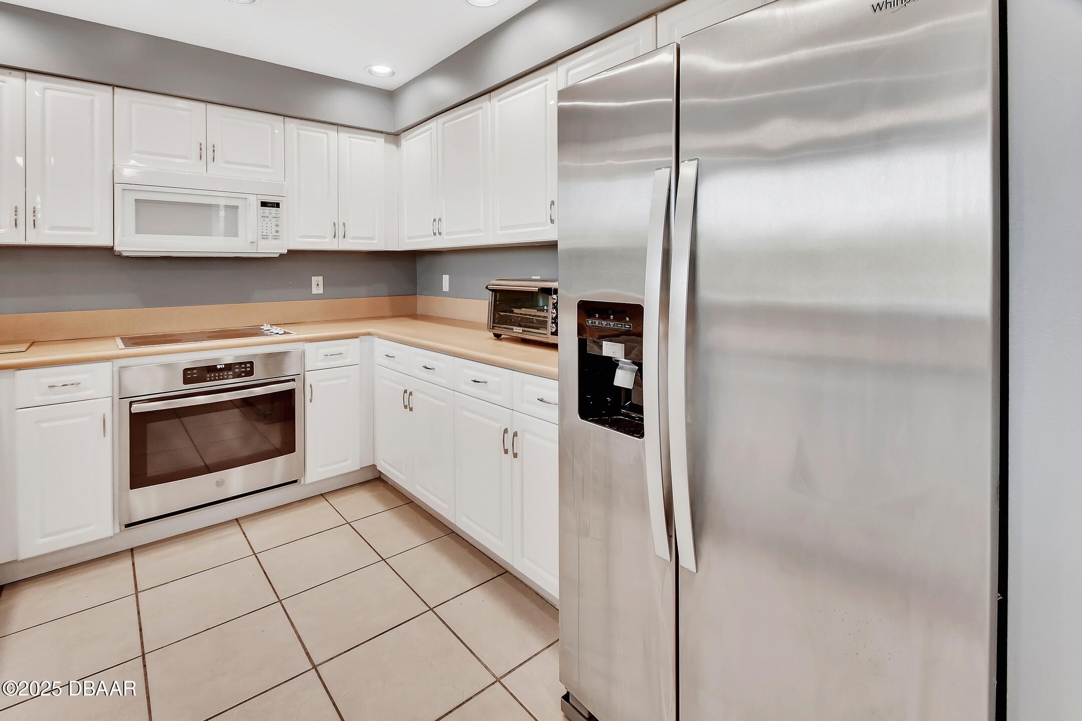 4623 Rivers Edge Village Lane, Unit 6308 Ponce Inlet, FL 32127 - Photo 35 of 55 a kitchen with cabinets and appliances