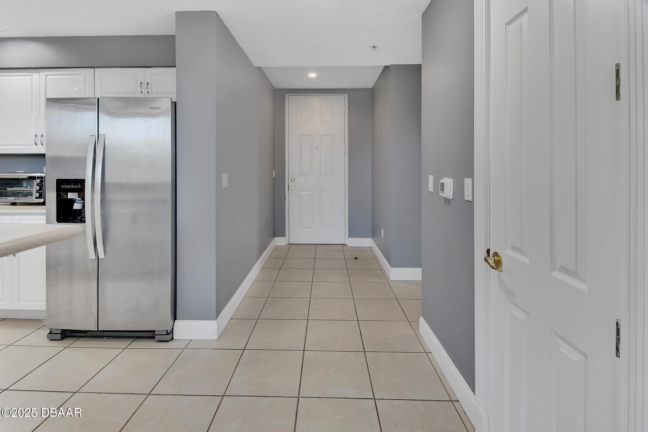 4623 Rivers Edge Village Lane, Unit 6308 Ponce Inlet, FL 32127 - Photo 36 of 55 a view of a refrigerator in kitchen and an empty room