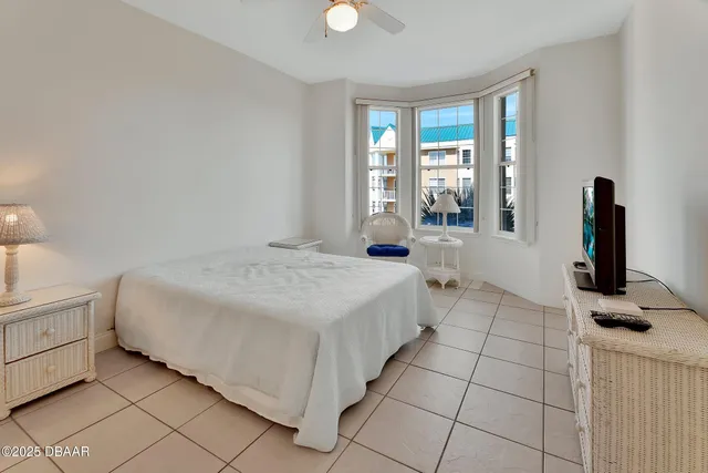a balcony with chairs and with potted plants
