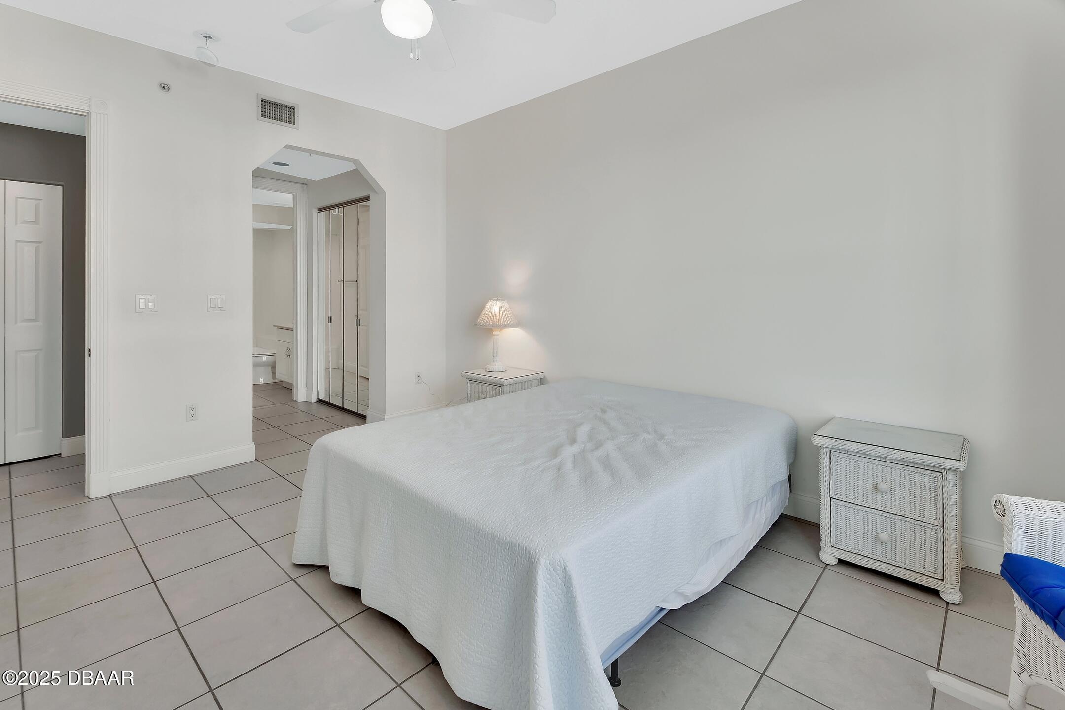 4623 Rivers Edge Village Lane, Unit 6308 Ponce Inlet, FL 32127 - Photo 39 of 55 a bedroom with a bed and cabinets