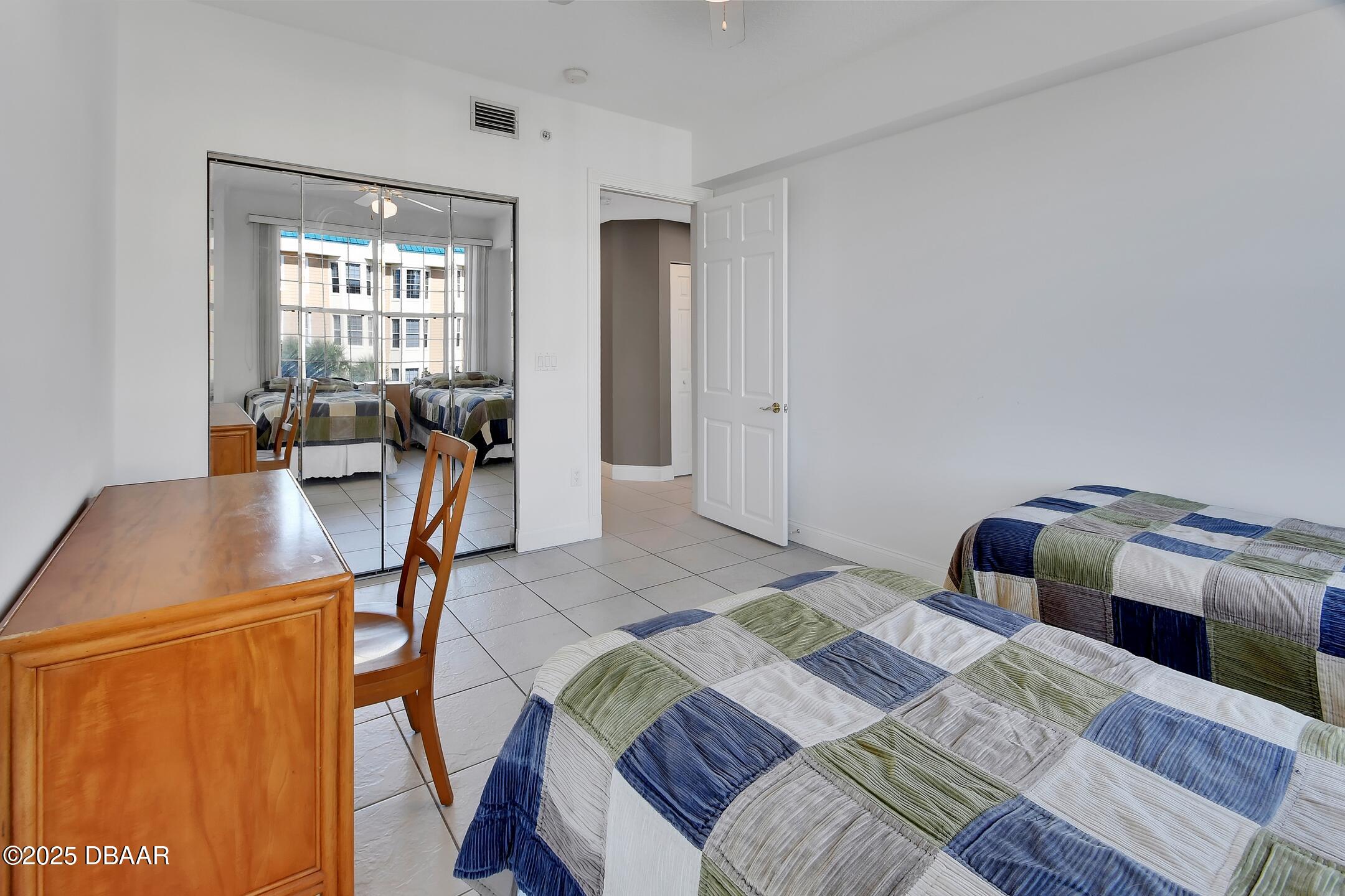 4623 Rivers Edge Village Lane, Unit 6308 Ponce Inlet, FL 32127 - Photo 43 of 55 a bedroom with a bed and wooden floor