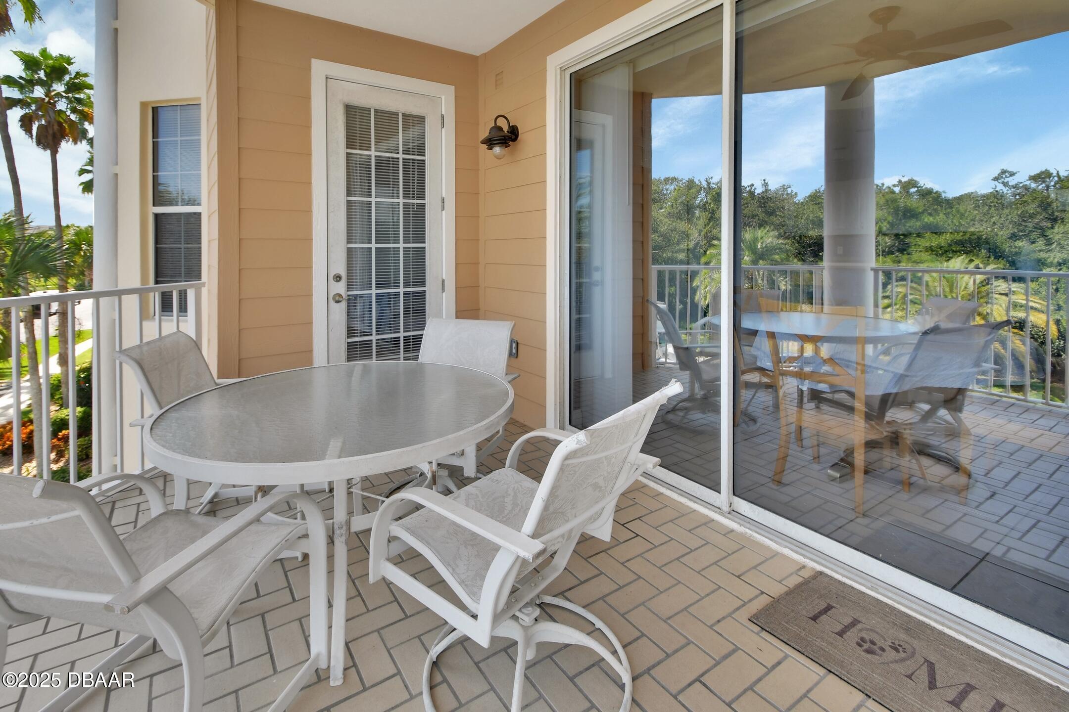 4623 Rivers Edge Village Lane, Unit 6308 Ponce Inlet, FL 32127 - Photo 46 of 55 a dining room with furniture and a floor to ceiling window