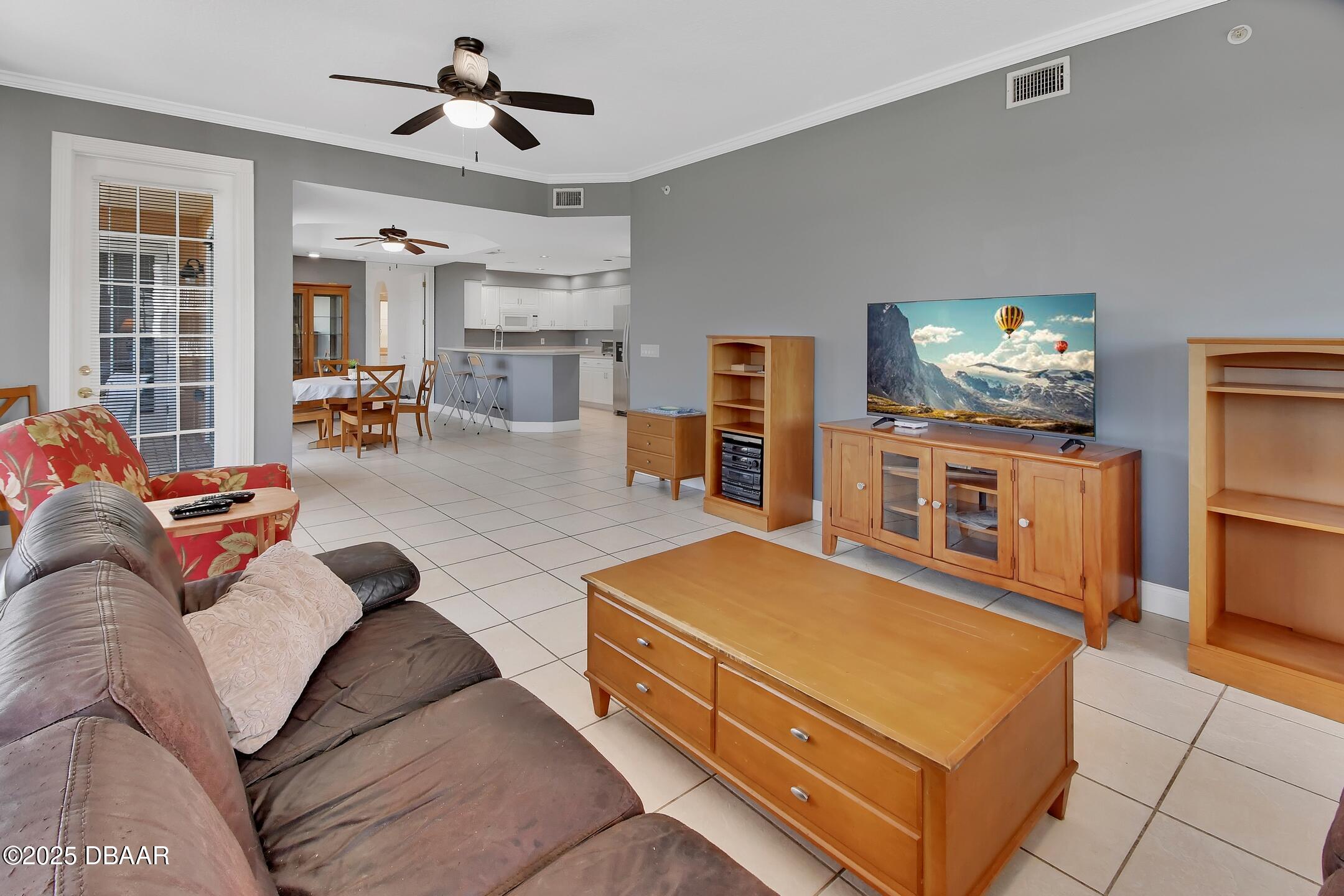 4623 Rivers Edge Village Lane, Unit 6308 Ponce Inlet, FL 32127 - Photo 5 of 55 a living room with furniture and a flat screen tv