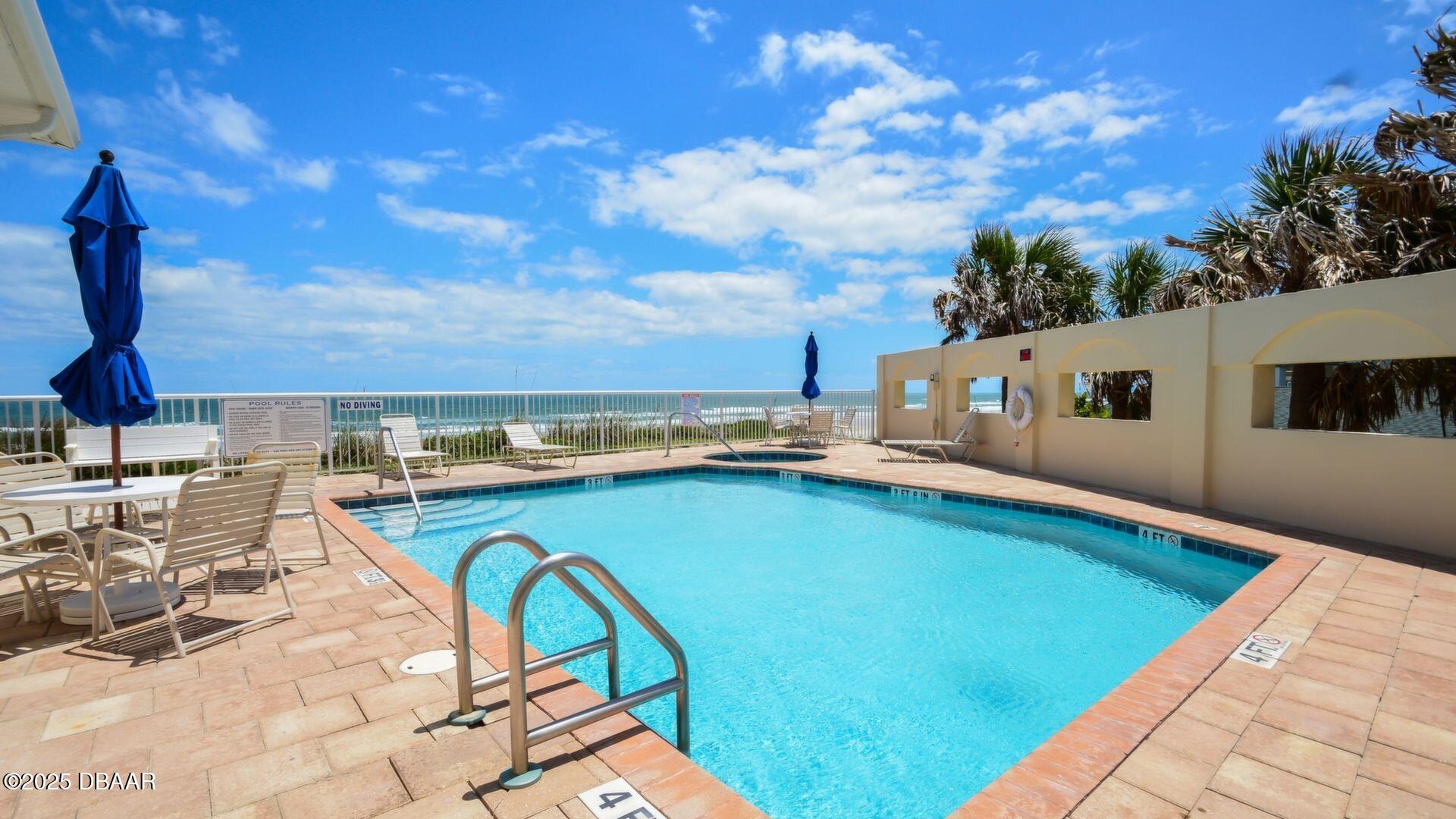 4623 Rivers Edge Village Lane, Unit 6308 Ponce Inlet, FL 32127 - Photo 52 of 55 a view of a swimming pool with outdoor seating and plants