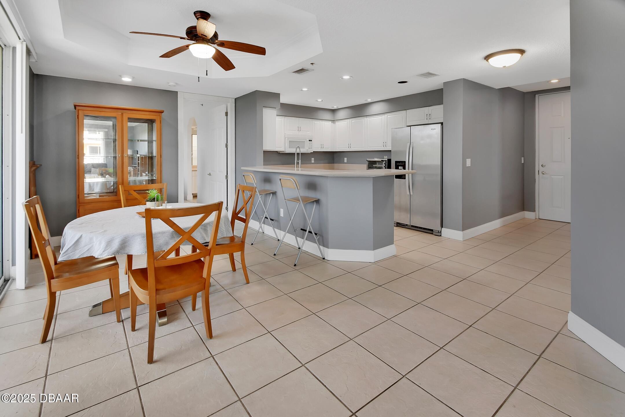 4623 Rivers Edge Village Lane, Unit 6308 Ponce Inlet, FL 32127 - Photo 6 of 55 a view of a dining room with furniture