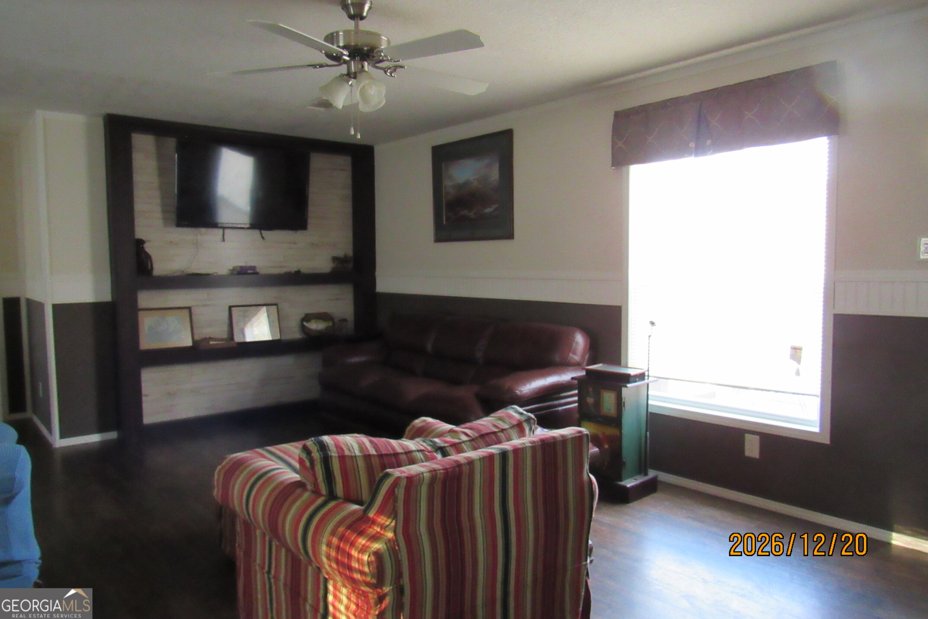 98 Lookout Trail Sparta, GA 31087 - Photo 5 of 10 a living room with furniture a flat screen tv and kitchen view