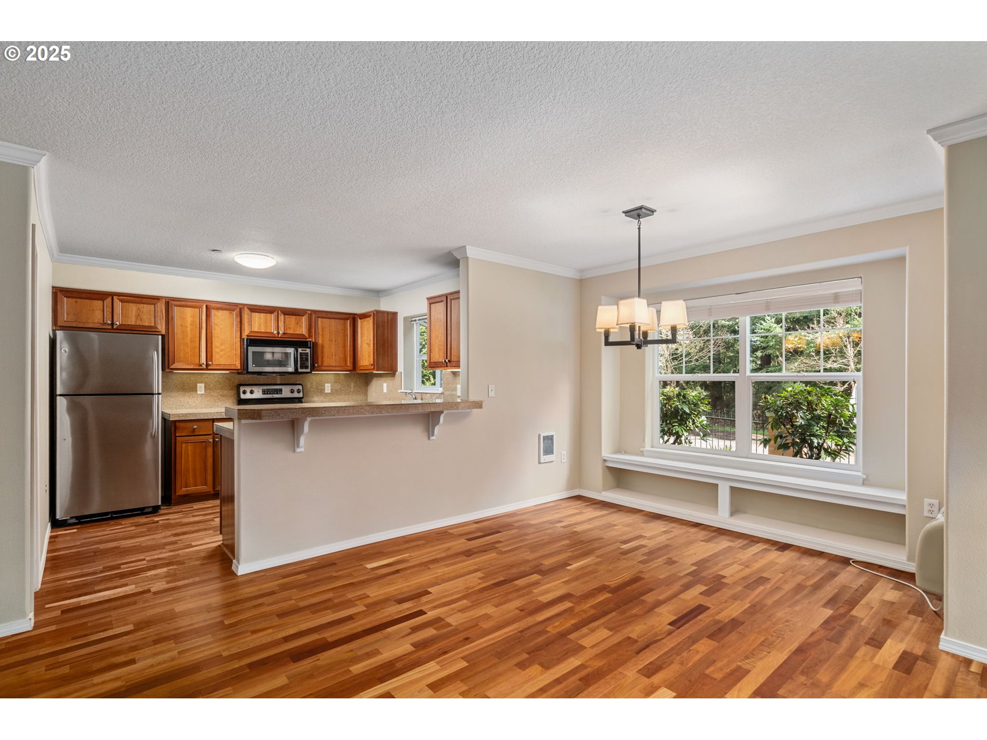30406 Southwest Ruth Street, Unit 78 Wilsonville, OR 97070 - Photo 11 of 45 a view of a kitchen with wooden floor and a kitchen
