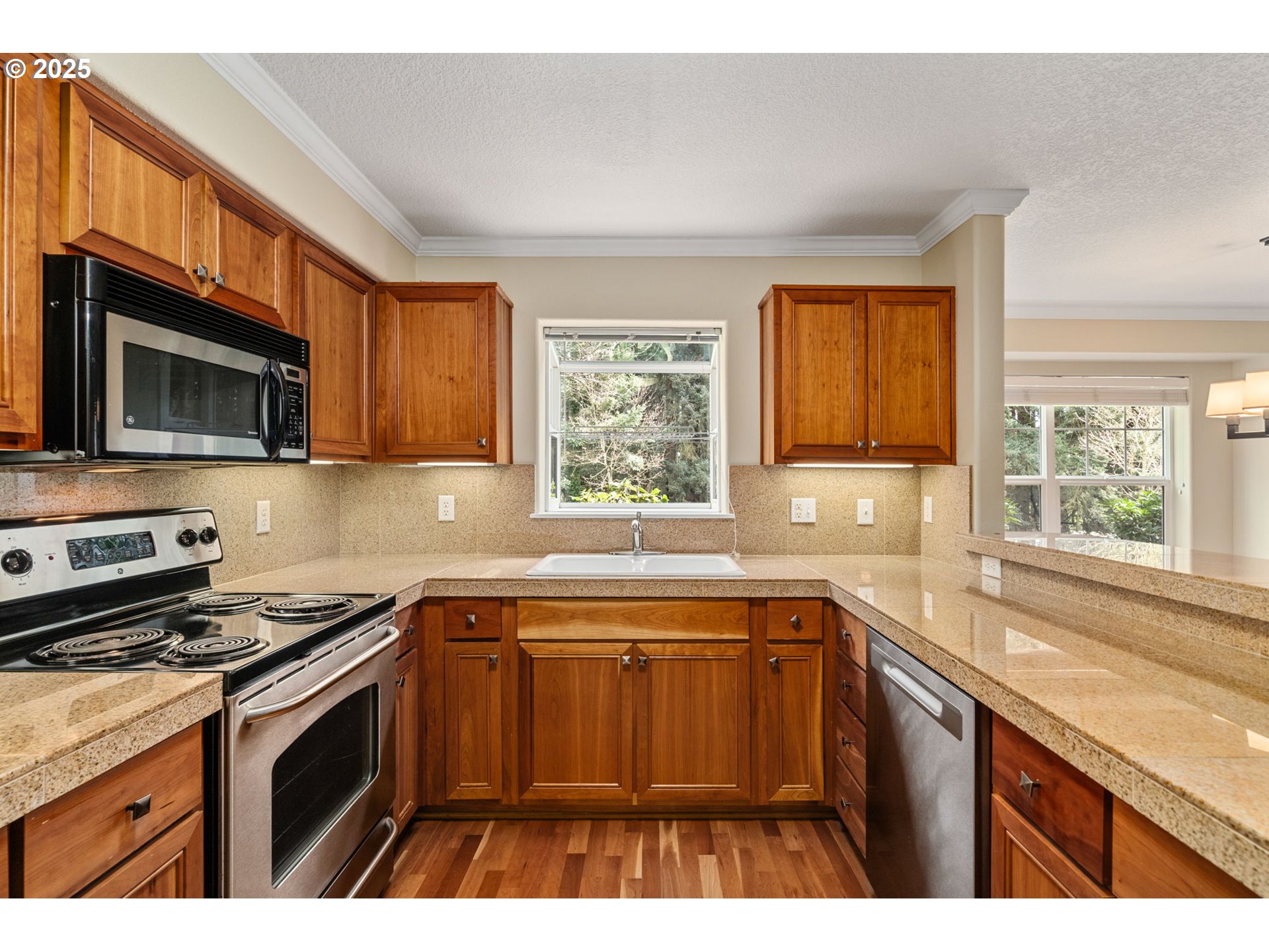 30406 Southwest Ruth Street, Unit 78 Wilsonville, OR 97070 - Photo 13 of 45 a kitchen with stainless steel appliances a sink stove and microwave
