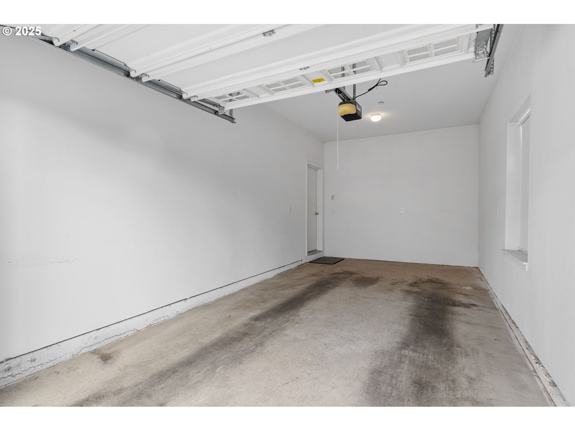 30406 Southwest Ruth Street, Unit 78 Wilsonville, OR 97070 - Photo 32 of 45 a view of a garage with wooden floor