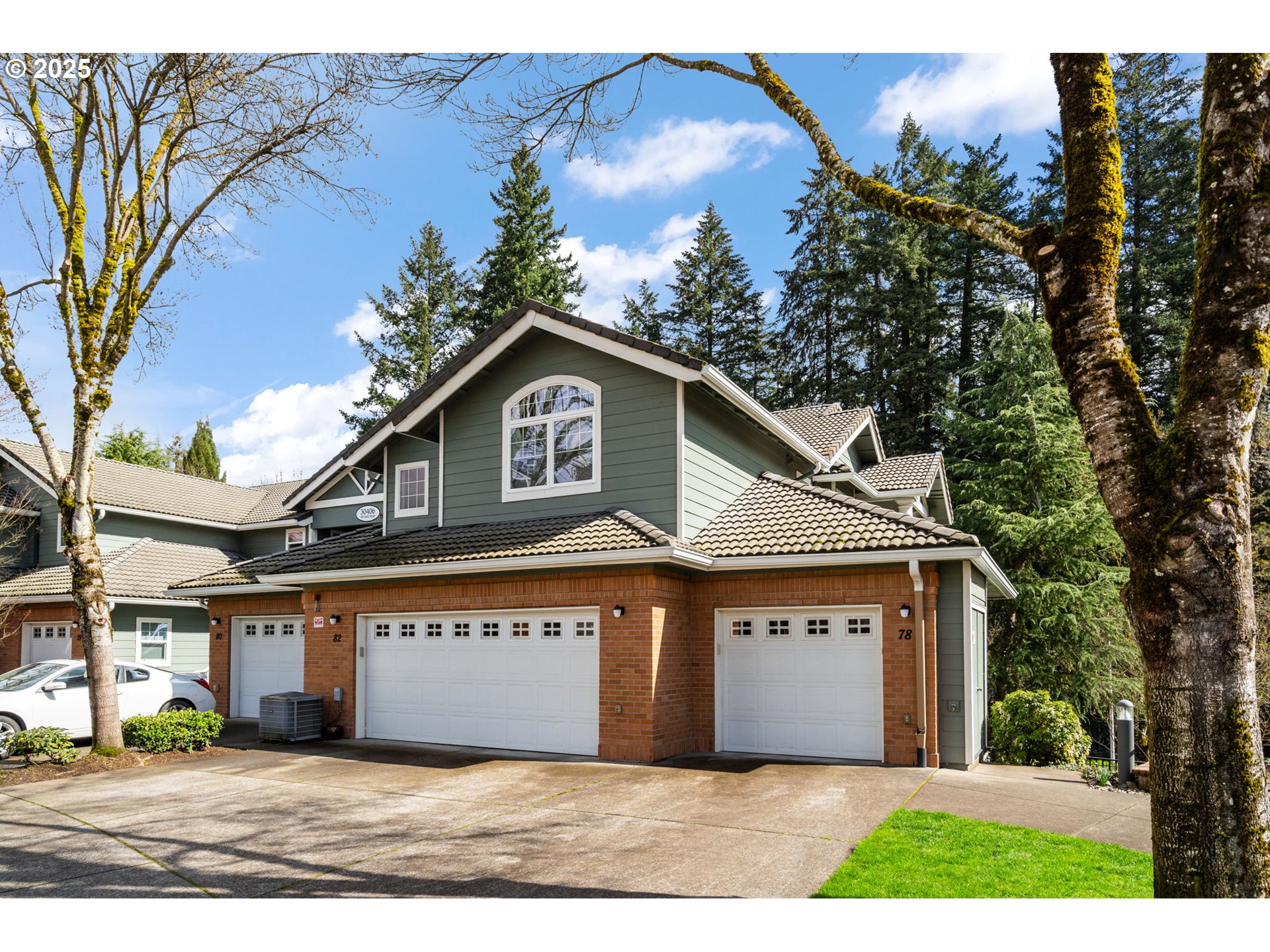 30406 Southwest Ruth Street, Unit 78 Wilsonville, OR 97070 - Photo 4 of 45 a front view of a house with a yard and garage