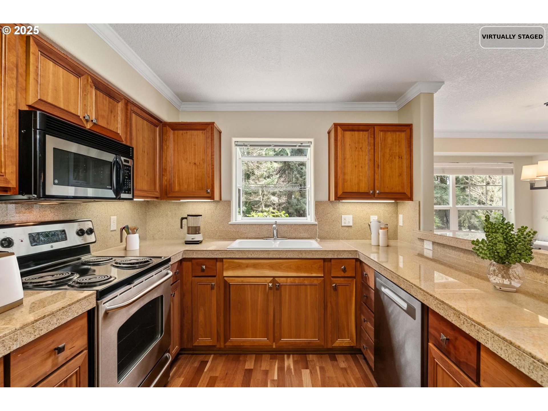 30406 Southwest Ruth Street, Unit 78 Wilsonville, OR 97070 - Photo 45 of 45 a kitchen with stainless steel appliances a sink a stove a microwave cabinets and a window