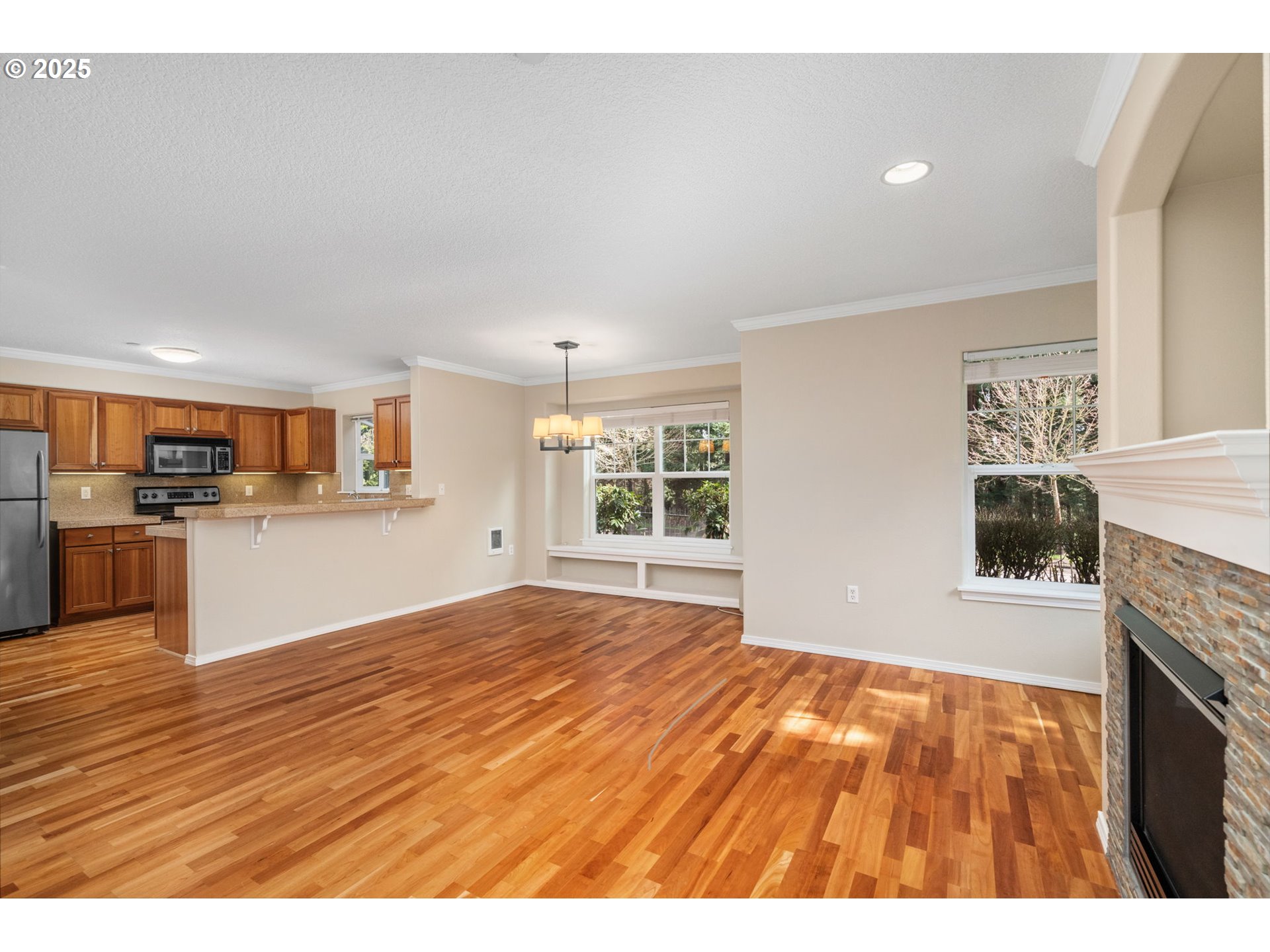 30406 Southwest Ruth Street, Unit 78 Wilsonville, OR 97070 - Photo 10 of 45 a view of an empty room with window and wooden floor