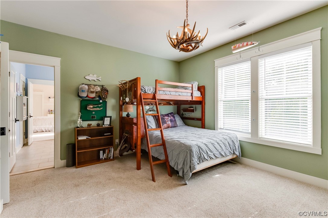 206 Running Cedar Lane Henrico, VA 23229 - Photo 18 of 33 a bedroom with a bed and a chandelier