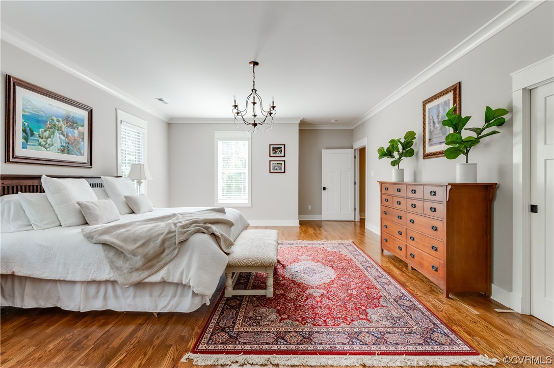 206 Running Cedar Lane Henrico, VA 23229 - Photo 24 of 33 a spacious bedroom with a bed a dresser and painting on the wall