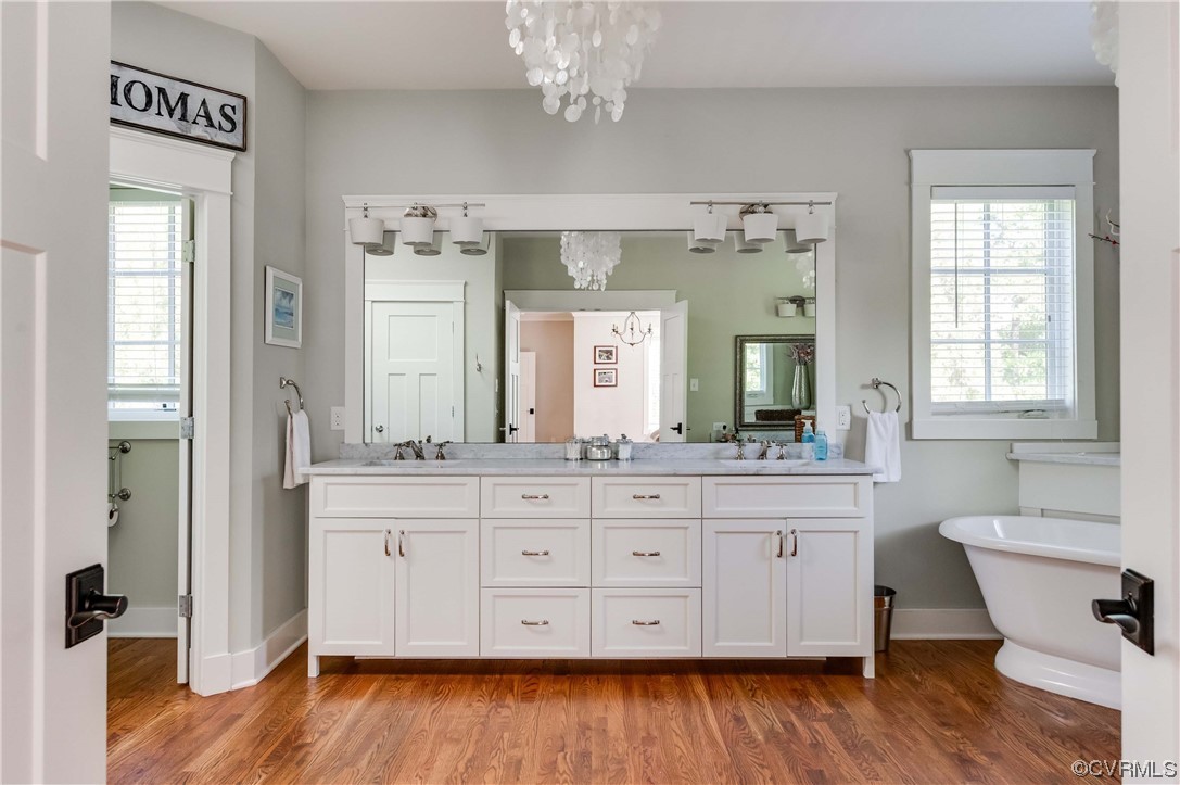 206 Running Cedar Lane Henrico, VA 23229 - Photo 25 of 33 a spacious bathroom with a granite countertop wooden floor a sink and a window