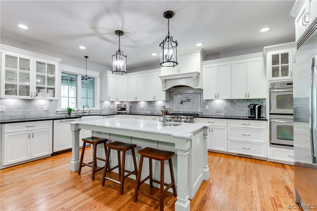 206 Running Cedar Lane Henrico, VA 23229 - Photo 10 of 33 a kitchen with stainless steel appliances granite countertop a stove top oven a refrigerator a sink and white cabinets with wooden floor