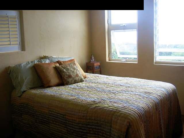 438 Kaupakalua Road Haiku, HI 96708 - Photo 13 of 18 a bed sitting in a bedroom next to a window