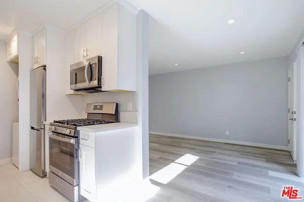 a kitchen with stainless steel appliances granite countertop a sink and dishwasher