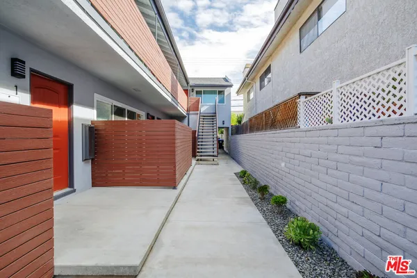 a pathway of a house with a yard